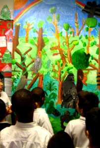 Students discussing the meaning in the large rainforest mural.
